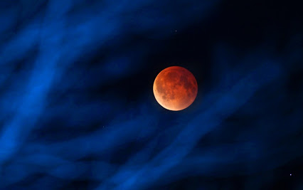 The moon glows a red hue during a total lunar eclipse Tuesday, April 15, 2014, as seen from the Milwaukee area. That eclipse was the first of four total lunar eclipses to take place between 2014 to 2015. (AP Photo/Milwaukee Journal-Sentinel, Mike De Sisti)